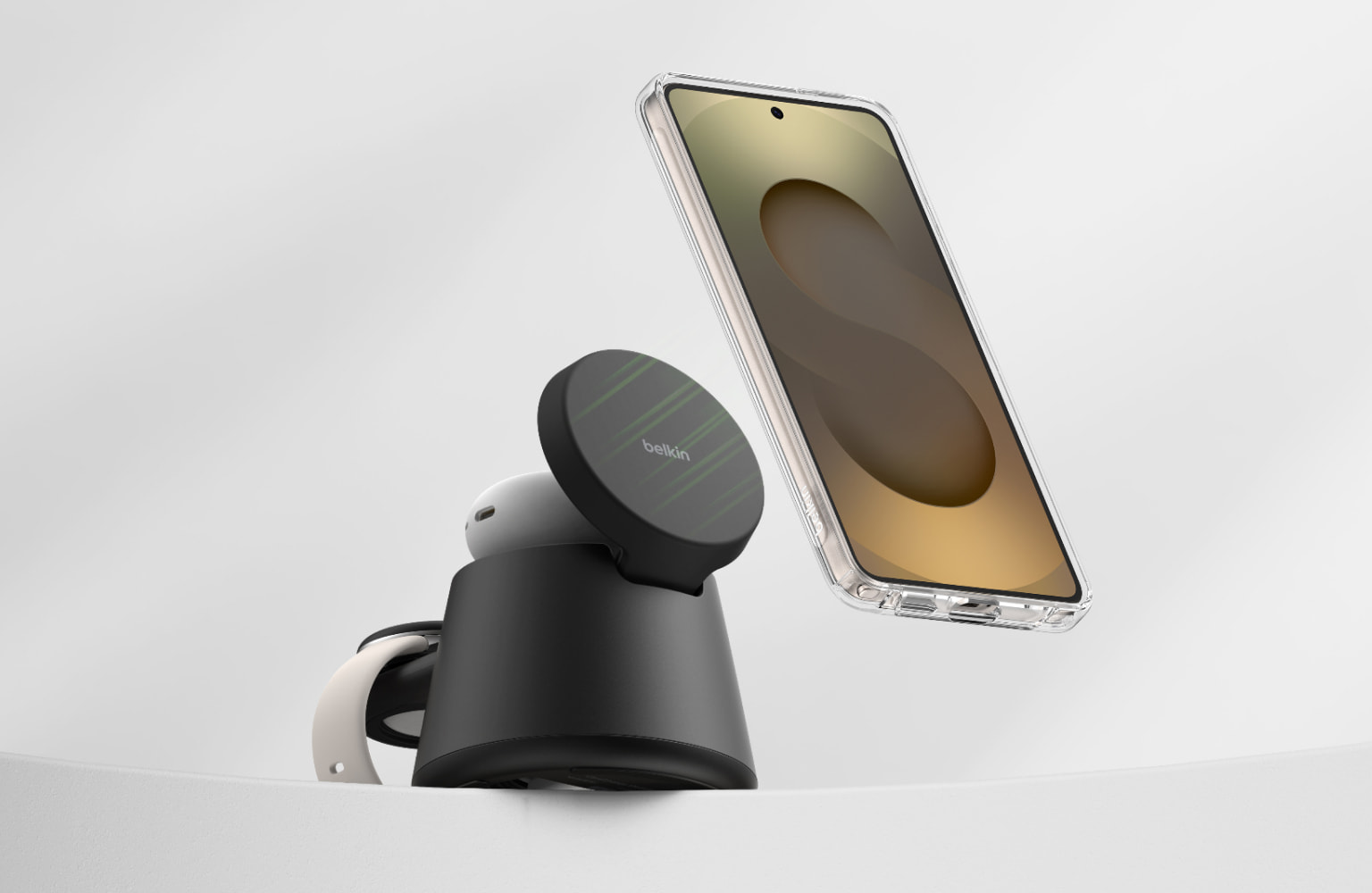Smartphone hovering above a Belkin magnetic wireless charging stand, illustrating hands-free charging and magnetic alignment.