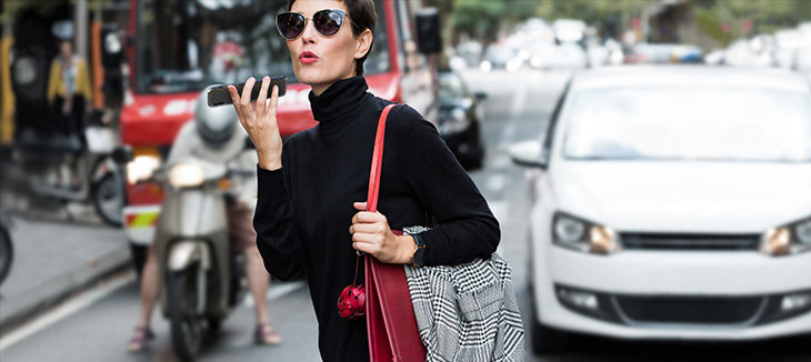 Woman using iPhone while in a crosswalk